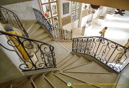 Ornamental staircase leading down from the 1st floor to the Sign Gallery.